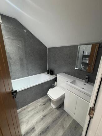 A modern, clean bathroom featuring a sleek whit...