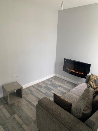 Cozy living room featuring a modern electric fi...