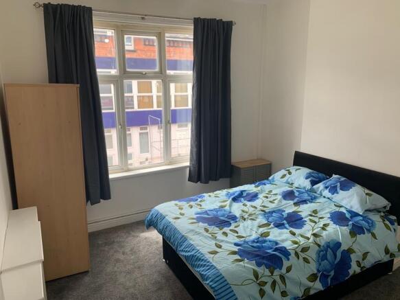 Bright and cozy double bedroom featuring a comf...