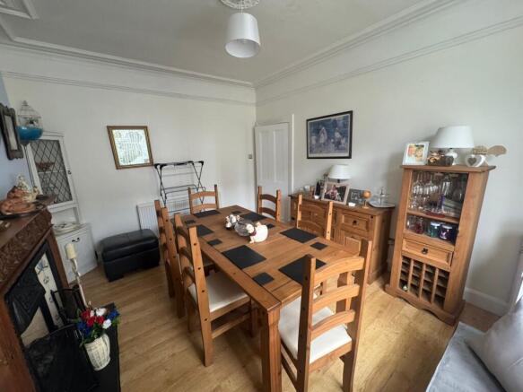 A cozy living room featuring a wooden dining ta...