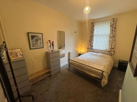 A cozy and well-kept double bedroom featuring a...