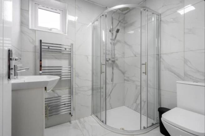 A modern bathroom featuring a stylish shower en...