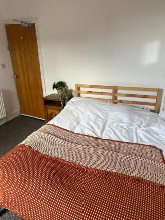 A bright and welcoming double bedroom featuring...
