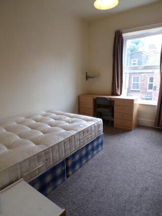 This charming double bedroom features a comfort...