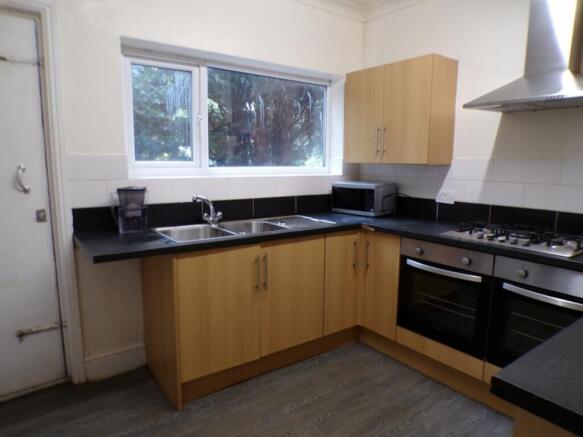 This inviting kitchen features modern cabinetry...