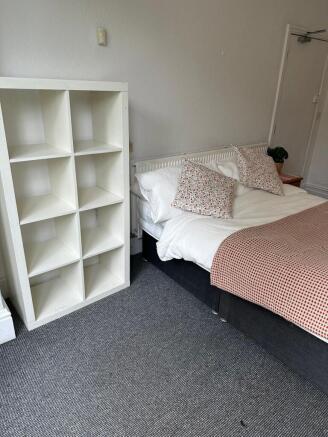 A cosy double bedroom featuring a comfortable b...