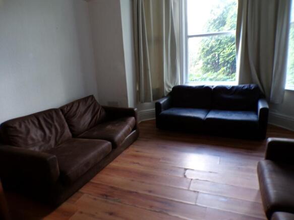 A spacious and inviting living room with ample ...