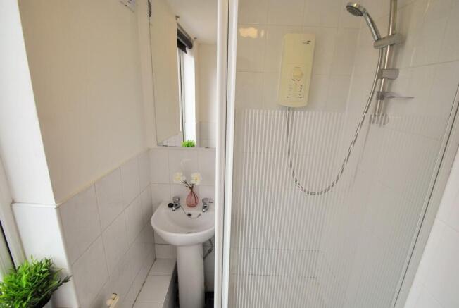 A modern bathroom featuring a sleek shower unit...