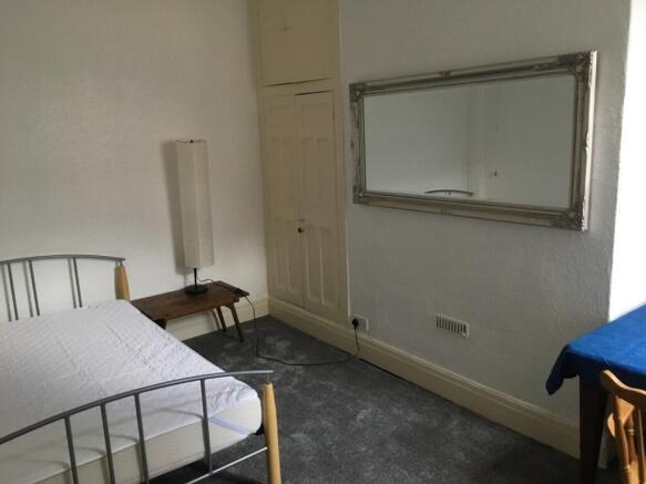 A cozy double bedroom featuring a comfortable b...