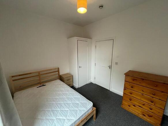 A bright and tidy double bedroom featuring ampl...