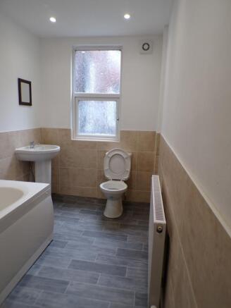 A modern bathroom featuring a stylish bathtub, ...