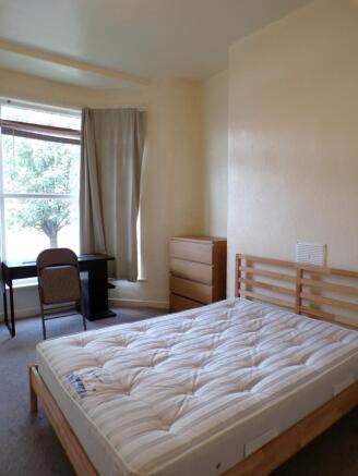A bright and spacious double bedroom featuring ...
