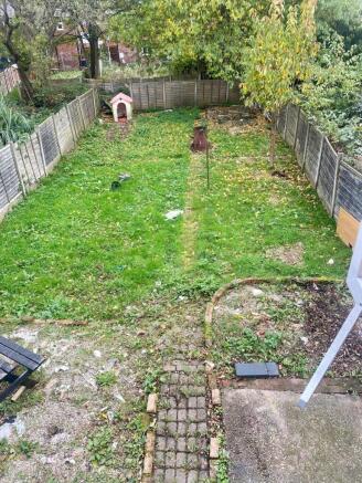 A spacious and well-maintained garden with a lu...