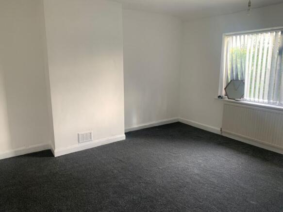 A bright and clean double bedroom featuring a l...