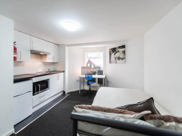 Bright and modern living room featuring a compa...