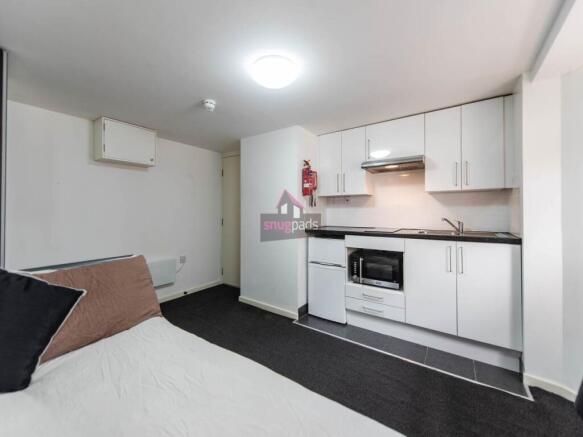 Bright and tidy compact kitchen featuring moder...