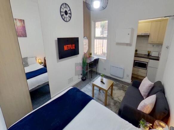 A cozy double bedroom featuring a comfortable d...