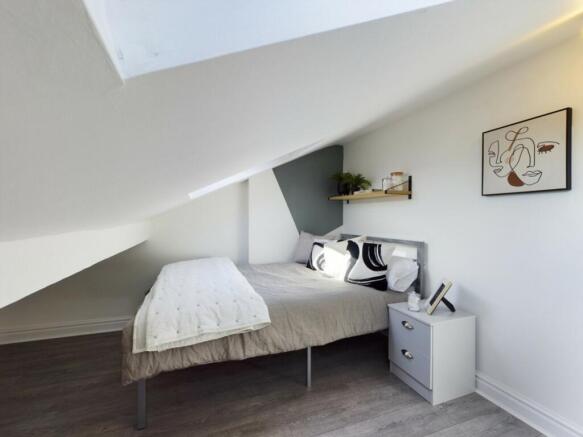 A cozy and inviting double bedroom with ample n...