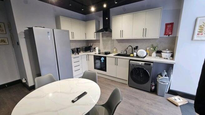 A modern, well-maintained kitchen with sleek wh...