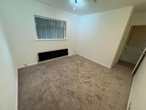 A bright and tidy double bedroom with neutral w...