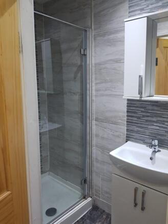 A modern bathroom featuring a shower area with ...