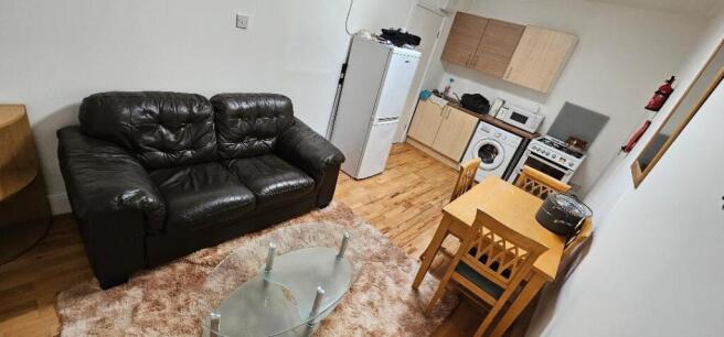 A cozy living area featuring a black leather so...