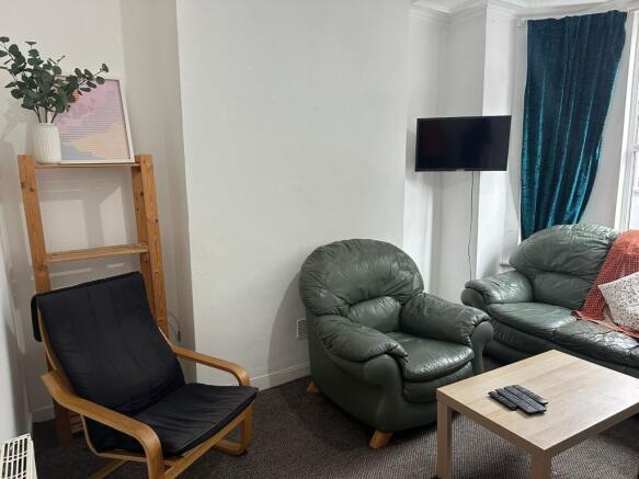 A cozy living room featuring comfortable leathe...