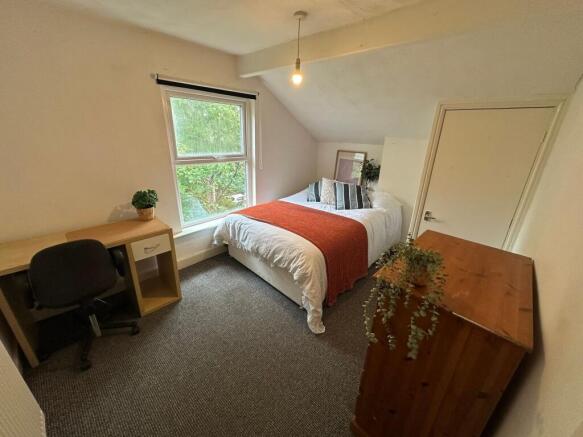 A bright, well-maintained bedroom featuring a c...