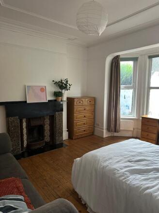 Bright and inviting master bedroom with a large...