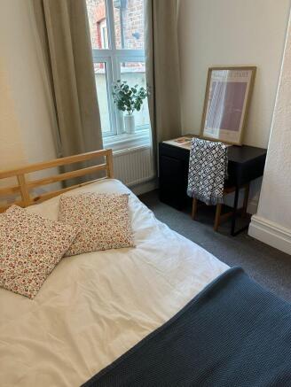 Bright and cozy double bedroom with a simple wo...