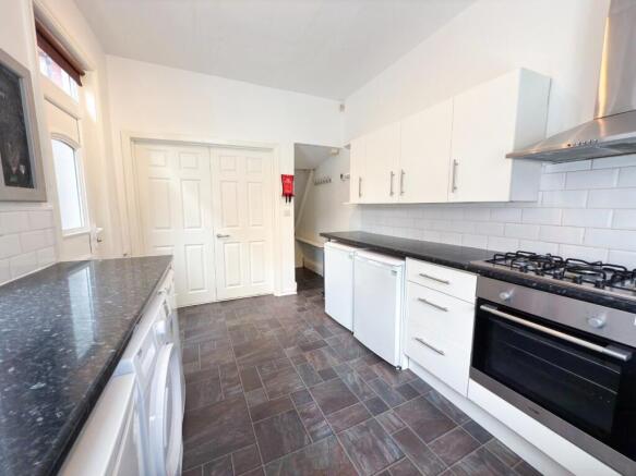 Bright and modern kitchen with ample white cabi...