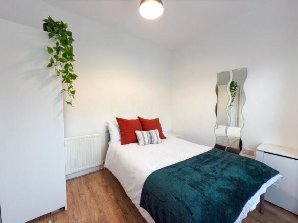 A bright and spacious master bedroom featuring ...