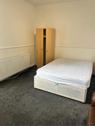 A spacious double bedroom with potential for pe...
