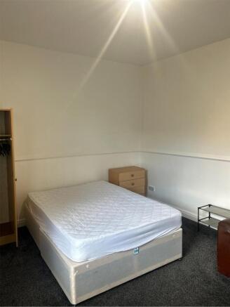 A spacious and bright double bedroom, ideal for...