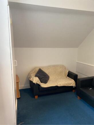 A cozy living room with comfortable seating, pe...