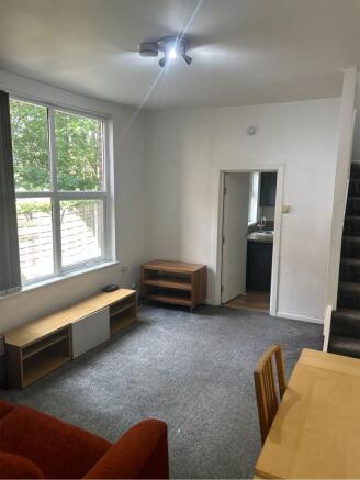 A spacious and inviting living room filled with...