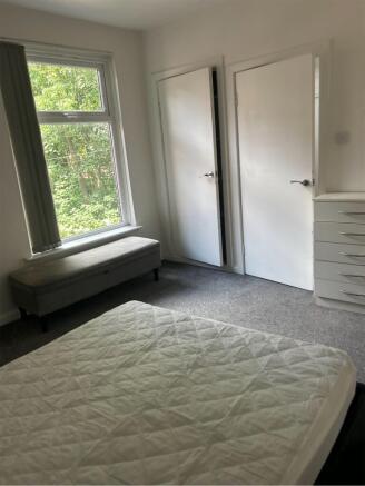 A bright and spacious double bedroom featuring ...