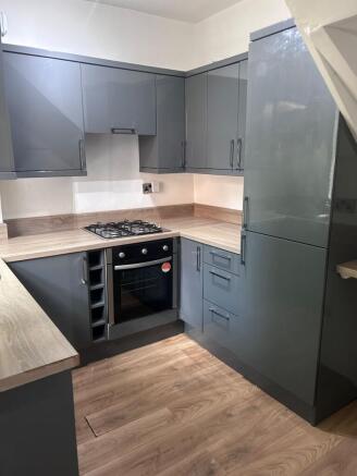A modern and tidy kitchen featuring sleek cabin...