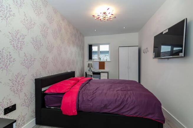 A spacious and well-decorated large double bedr...
