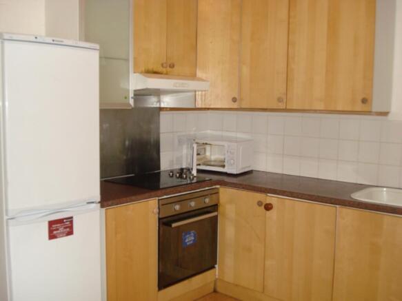 A functional kitchen equipped with essential ap...