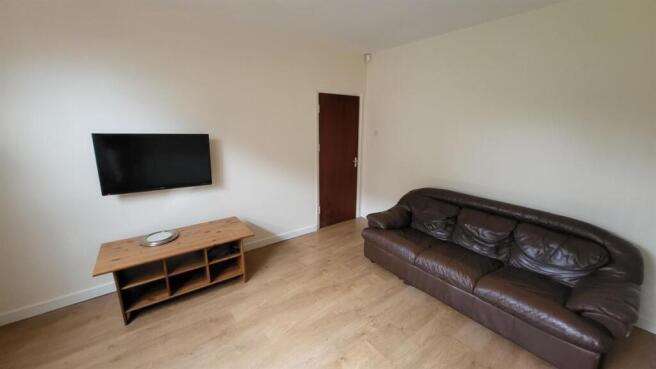 Spacious and well-lit living room featuring a l...