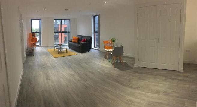 A spacious and modern living room with large wi...