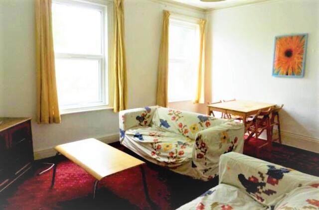 A bright and welcoming living room featuring la...