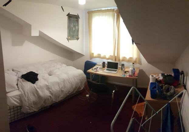 A cozy bedroom with a double bed, natural light...