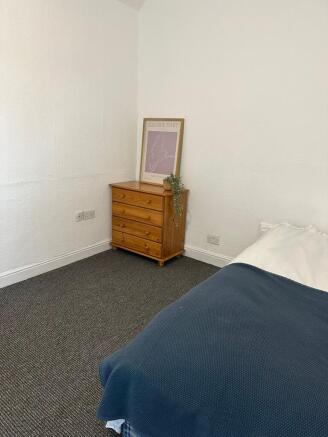 A cozy and well-maintained bedroom featuring a ...