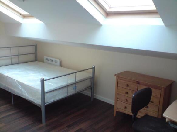 A bright and spacious double bedroom featuring ...