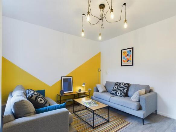 Bright and inviting living room featuring styli...