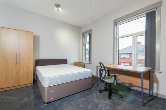 Bright and spacious double bedroom featuring a ...