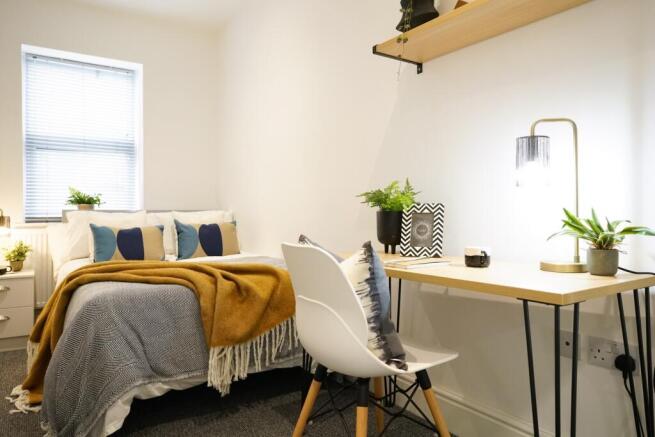 A bright and inviting double bedroom featuring ...