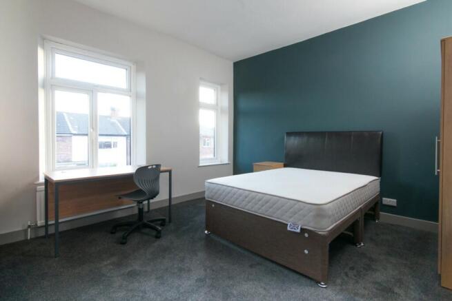 Bright and spacious double bedroom featuring la...